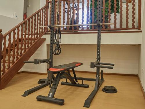 a gym with a bench and a staircase at Hotel Ca'l Bisbe in Sóller