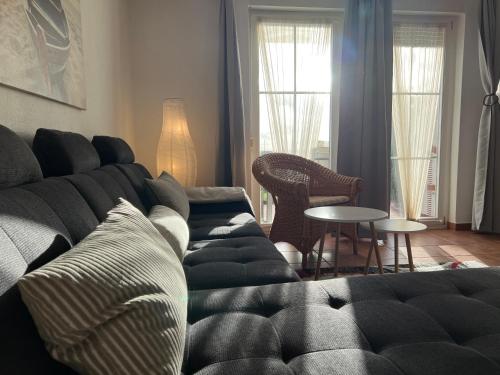 a living room with a couch and a table at Apartment Ostseebrise im Ferienpark in Sagard
