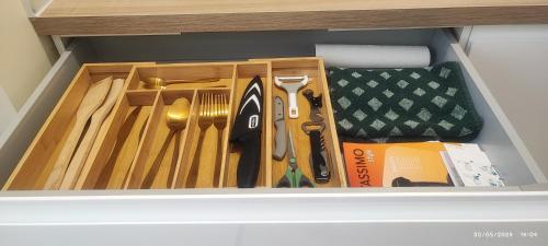 a drawer filled with wooden utensils in a cabinet at La Green Room in Poitiers