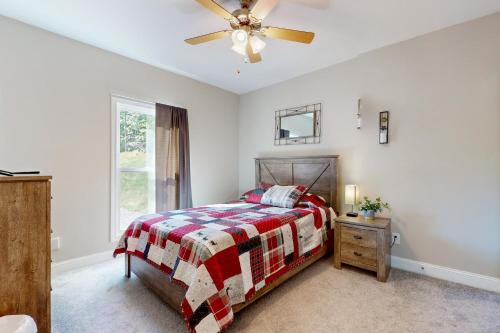a bedroom with a bed and a ceiling fan at Hidden Escape with a View in Mill Spring