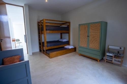 a room with two bunk beds and a television at Casona con alberca privada in San Miguel de Allende