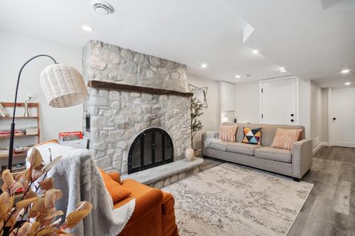 a living room with a stone fireplace at Haven Suite in London, On 2Br, 1Bath with free washer and dryer in London