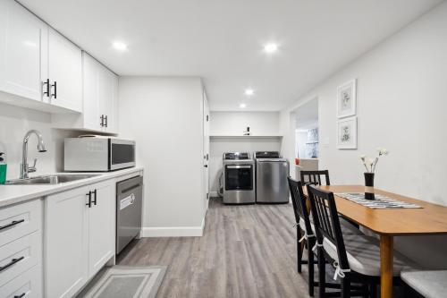 a kitchen and dining room with a table and chairs at Haven Suite in London, On 2Br, 1Bath with free washer and dryer in London