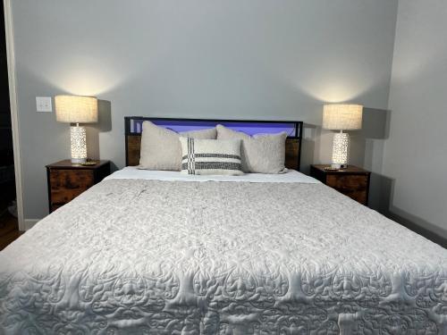 a bedroom with a large white bed with two lamps at Murrels Inlet House Private Heated Saltwater Pool in Myrtle Beach
