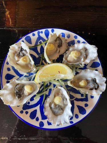 a blue and white plate of oysters with a lemon at Shannaghs Sweet Escape in Powell River