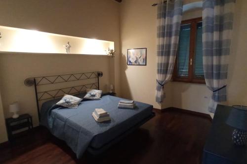 a bedroom with a bed with two towels on it at CASA in PIAZZA a due passi dagli imbarchi e dal centro storico in Livorno