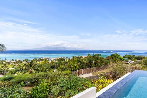 an ocean view from a villa with a swimming pool at Luxurious 3BR Villa with Infinity Pool in Temae