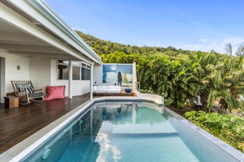 a swimming pool in the backyard of a house at Luxurious 3BR Villa with Infinity Pool in Temae
