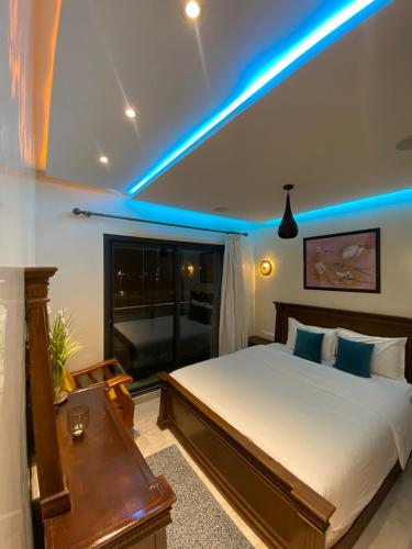 a bedroom with a bed with a blue light at PRESTIGIA ESSAOUIRA MOGADOR Luxury Ocean View in Essaouira