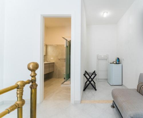 a living room with a couch and a refrigerator at La Corte di Colombo in Favignana