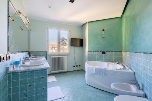 a bathroom with two sinks and a tub and a toilet at "Il Vicolo" Sunny Lake Garda Villa in Toscolano Maderno