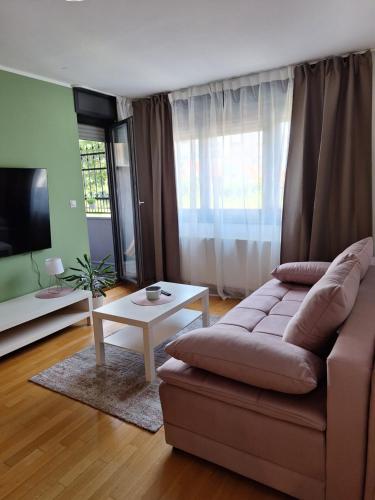 a living room with a couch and a table at Apartman Lory, Zagreb, Downtown, with own parking in the garage in Zagreb