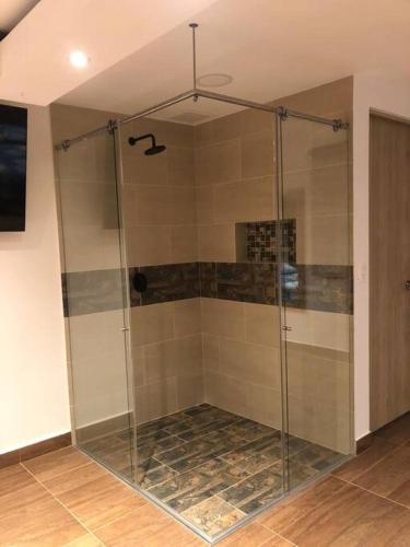a shower with a glass enclosure in a room at Finca el Mirador in Manizales