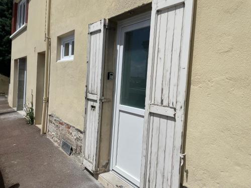 an open white door of a building with a window at Le Cocon Forézien - RDC - Proche gare et centre - Wifi in Feurs