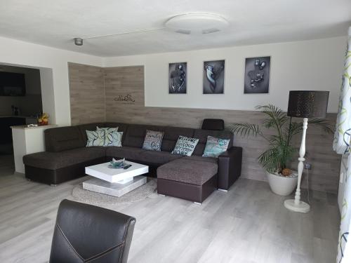 a living room with a couch and a table at Ferienwohnung Witting in Wenns