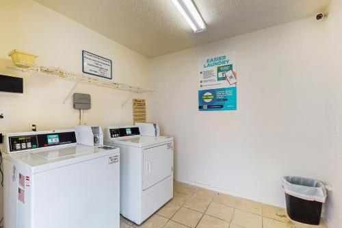 a laundry room with a washer and dryer at Quaint Oasis in Padre Island