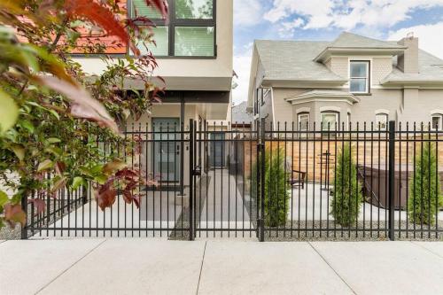 a black fence in front of a house at LuxuryDenver Studio w Hot Tub 2 Mi to Downtown in Denver