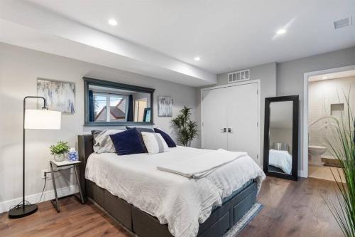 a bedroom with a large bed and a mirror at LuxuryDenver Studio w Hot Tub 2 Mi to Downtown in Denver