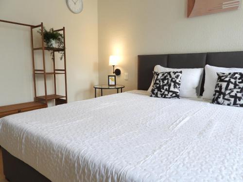 a bedroom with a large white bed with pillows at Singular Reforma in Mexico City
