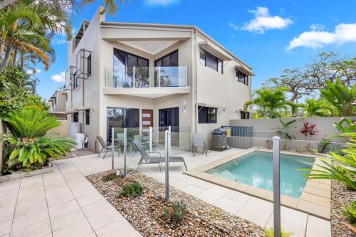 a house with a swimming pool in front of it at 'Bay View' with Pool and Rooftop Entertaining Area in Hervey Bay