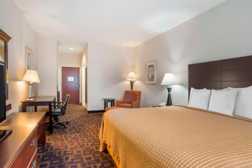 a hotel room with a bed and a desk at Best Western Carowinds in Fort Mill