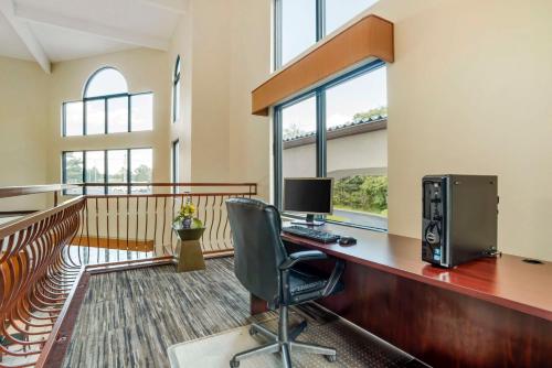 an office with a desk with a computer and a chair at Best Western Carowinds in Fort Mill