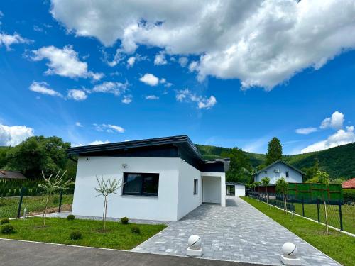 a white house with a black roof at Unavis Residence in Bihać