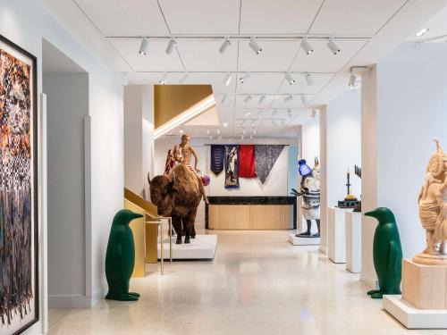 a gallery with statues and art on the walls at 21c Museum Hotel Chicago in Chicago