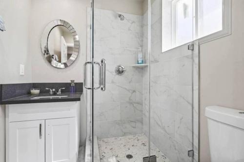 a bathroom with a shower with a glass door at Spacious family Guesthouse private entry near six flags in Santa Clarita