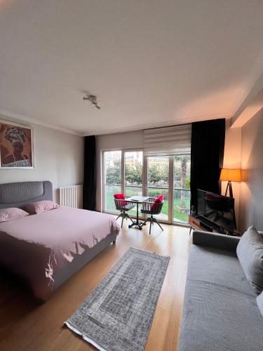 a bedroom with a bed and a table with a television at Beauty stüdyo Home in Istanbul