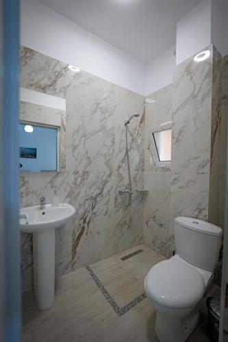 a bathroom with a toilet and a sink at Hotel Veliaj in Ksamil