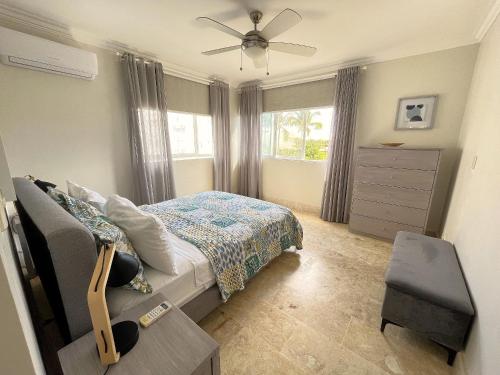a bedroom with a bed and a ceiling fan at Spectacular Penthouse Ocean Views. Playa Bavaro. Punta Cana in Punta Cana