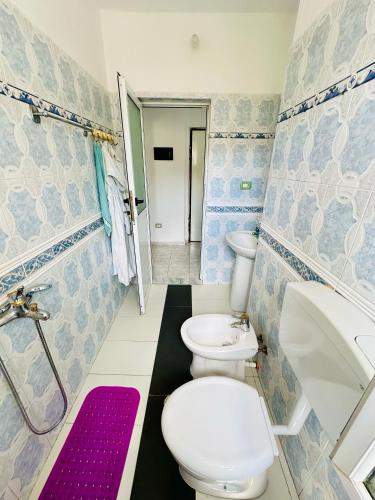 a bathroom with two toilets and a sink at Victoria's City Escape in Vlorë