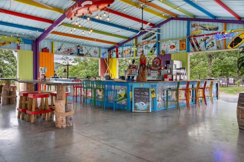 a restaurant with a bar and tables and chairs at Rock Lane Resort & Marina in Branson