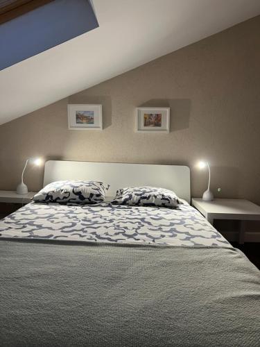 a bedroom with a large bed with two lamps at "SALERNO" Apartament w GIFFONI VALLE PIANA dla 6 osób, klimatyzowany, w pełni wyposażony in Giffoni Valle Piana