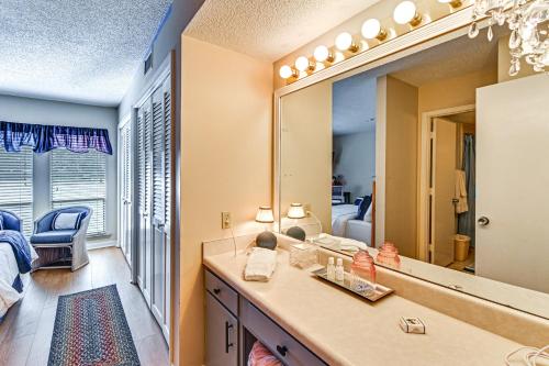 a bathroom with a vanity and a mirror at Lakeview Condo with Resort Pool 2 Miles to Golf! in Pinehurst