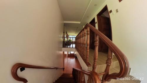 a winding staircase with wooden railings in a house at Hostal & Spa Casa Real in Baños
