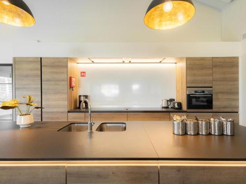 a kitchen with a sink and a counter top at Villa Mareon in Schorisse