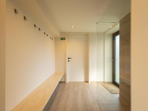 an empty hallway with white walls and wooden floors at Villa Mareon in Schorisse
