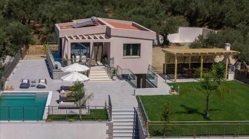 an aerial view of a house with a swimming pool at De Hierro Exclusive Villa - Magical Hospitality in a Villa with Pool and Breathtaking Views By Villa Mana Gers in Plános