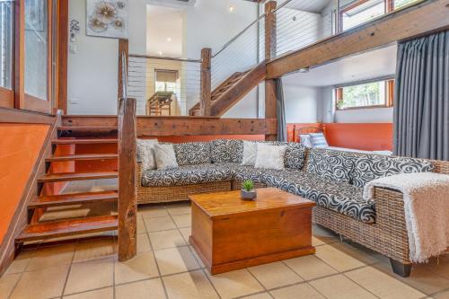 a living room with a couch and a table at Tasman Holiday Parks - Cairns Cool Waters in Cairns