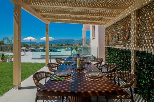 a table and chairs on a patio with a view at De Hierro Exclusive Villa - Magical Hospitality in a Villa with Pool and Breathtaking Views By Villa Mana Gers in Plános