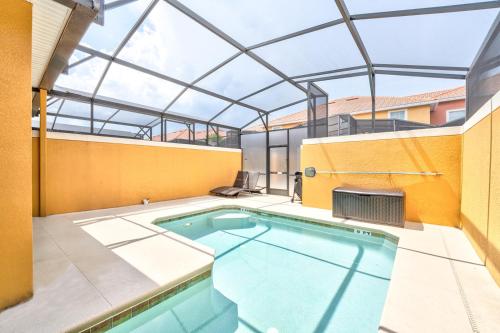 an indoor swimming pool with a glass roof at Beautiful Townhome just 8 miles from Disney in Kissimmee