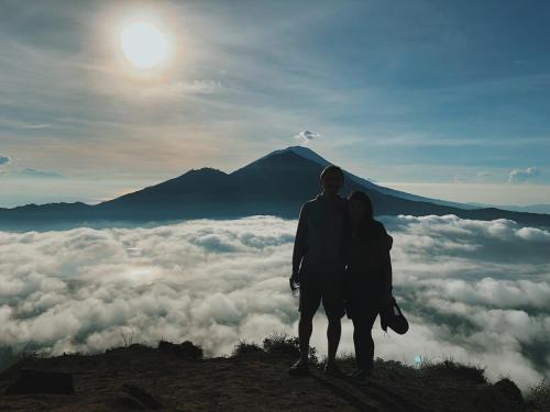 a man and a woman standing on top of a mountain at Villa SARY AKAR in Payangan