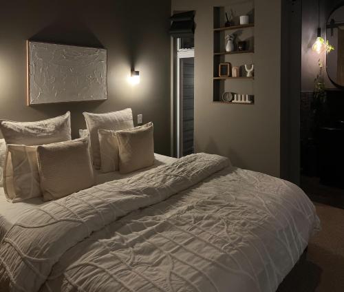 a bedroom with a large bed with white pillows at George - Luxe Residence with Private Rooftop in Adelaide