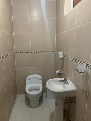 a small bathroom with a toilet and a sink at Quinta Doña Adita in Girón