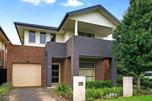 una casa de ladrillo con garaje en Blue Haven Retreat - Thornton Central 34, en Penrith