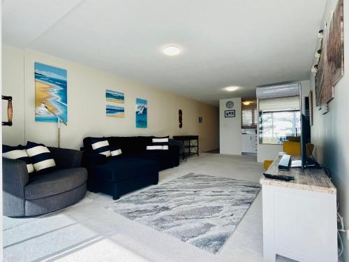 a living room with a couch and a tv in it at Park Towers-Goodwin Towers Holiday Units in Gold Coast