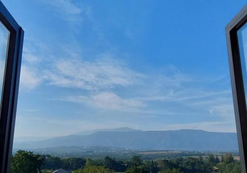 a view of the mountains from a window at Biciclette hotel khaoyai in Ban Bung Toei