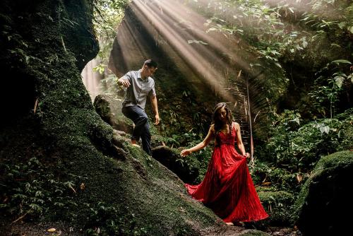 a man and a woman walking through a forest at Villa SARY AKAR in Payangan